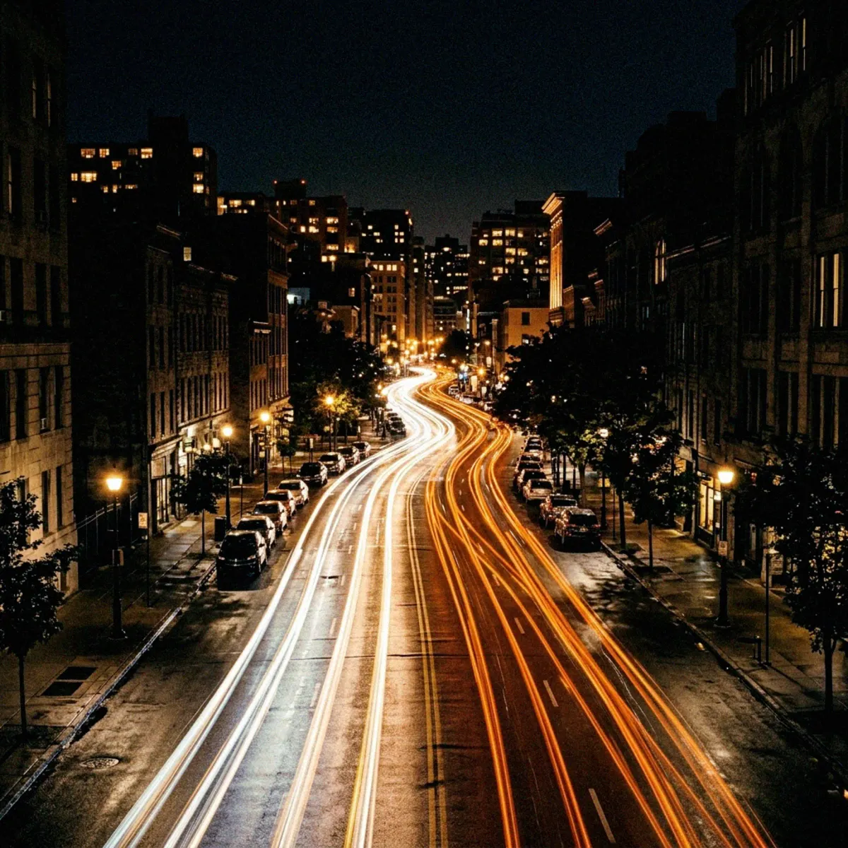 A city street at night with warm light trails.